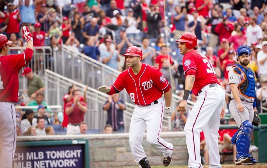 Washington Nationals Danny Espinoza (8) is greeted at the plate by Michael Morse (38) after his two-run home run in the bottom of the second inning. (Rod Lamkey Jr./The Washington Times)