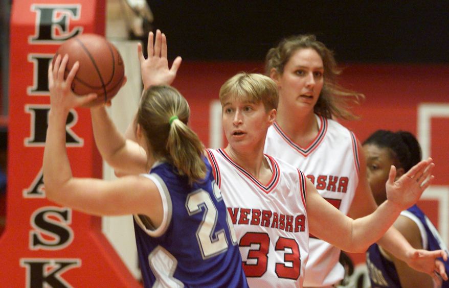 In a Dec. 12, 1999 photo, Nebraska's Charlie Rogers (33), guards Creighton's Corey Sweeney (22) during a women's basketball match in Lincoln, Neb. Rogers, who told police she was the victim of a vicious hate crime in July, 2012, was charged with making a false report Tuesday, Aug. 21, 2012 and pleaded not guilty to the misdemeanor charge. Authorities issued an arrest warrant for Rogers Tuesday morning. (AP Photo/Lincoln Journal Star, William Lauer)