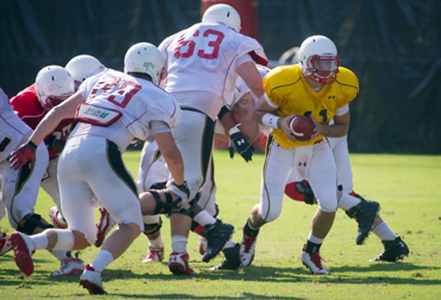 Terrapins quarterback Perry Hills (11) scrambles from the pocket during the Terrapins football practice at the University of Maryland in College Park, Md., Thursday, August 16, 2012. (Rod Lamkey Jr./The Washington Times)