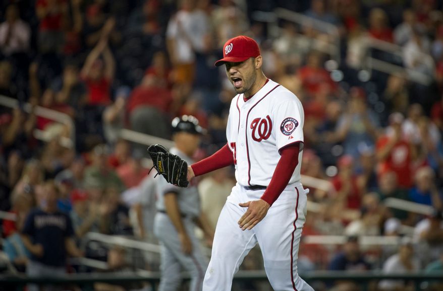 Washington Nationals relief pitcher Michael Gonzalez celebrates after sending the game into the bottom of the 11th inning in the Nationals' 5-4, 13-inning home victory over the Atlanta Braves on Aug. 20, 2012. (Rod Lamkey Jr./The Washington Times)