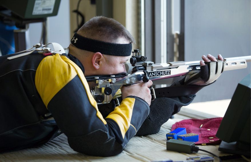 SFC Josh Olson, a U.S. Army Paralympic marksman, looks down his sight as he prepares to fire rifle at Wagner Range, in Ft. Benning, Ga., Thursday, May 31, 2012. Olson sustained heavy damage to his leg during an ambush attack in Iraq in 2003, in which his right leg had to be amputated. He's currently a apart of the wounded warrior program and the first active duty soldier to qualify for a Paralympics in the field of mixed 50 meter rifle and mixed 10 meter air rifle. (Andrew S. Geraci/The Washington Times)