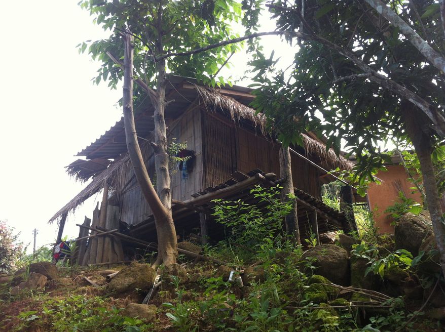 This July 21, 2012 photo shows a typical house in the Akha hill tribe village that is home to Akha Hill guest house. Perched at the head of a curving valley on the slopes of Doi Hang mountain, most of the village houses are still made of traditional bamboo, raised on stilts with covered outdoor platforms. But a few concrete houses have appeared, and even a handful of satellite dishes poking from the thatched rooftops. (Associated Press)