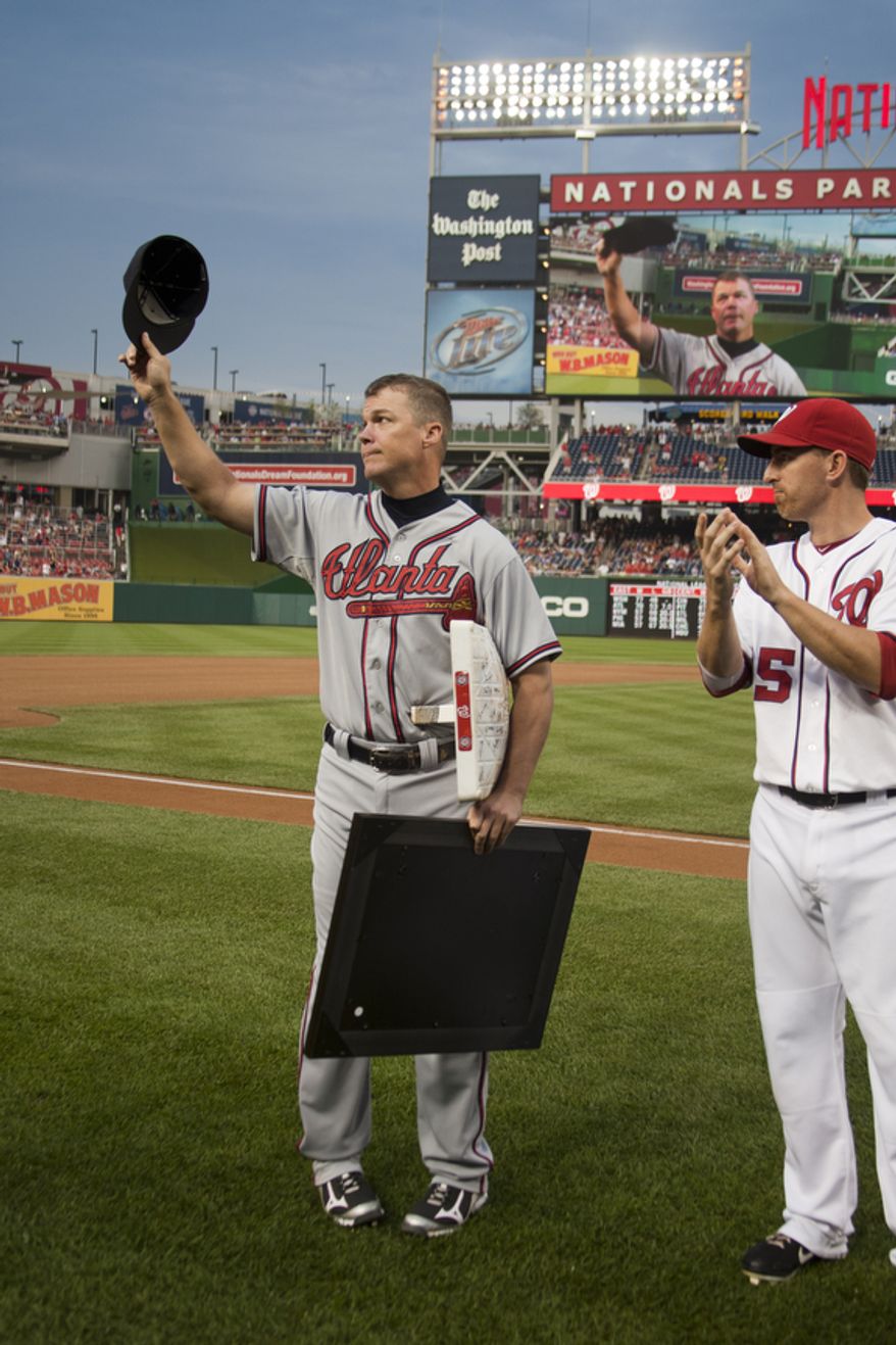 Chipper Jones waves to the crowd after a ceremony before the first pitch to honor veteran third baseman Chipper Jones, Wednesday, Aug. 22, 2012, in Washington, DC. Washington National Adam LaRoche looks on. (Craig Bisacre/The Washington Times)