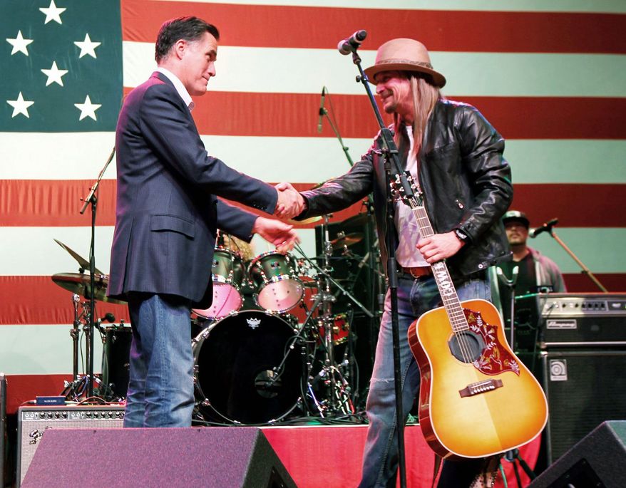 Mitt Romney shakes hands with Kid Rock after the rocker performed at a campaign rally in Royal Oak, Mich., during the primaries in February. (Associated Press)