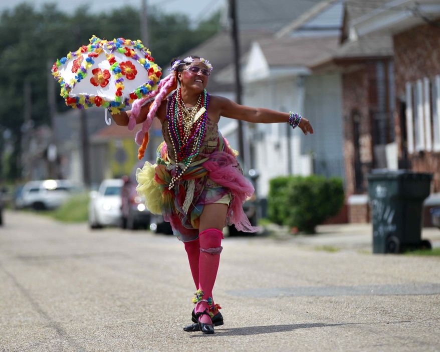 Jennifer Jones, a Grand Marshal for various bands and events, poses for a photo in the Treme section of New Orleans, Thursday, Aug. 23, 2012. (AP Photo/Gerald Herbert)