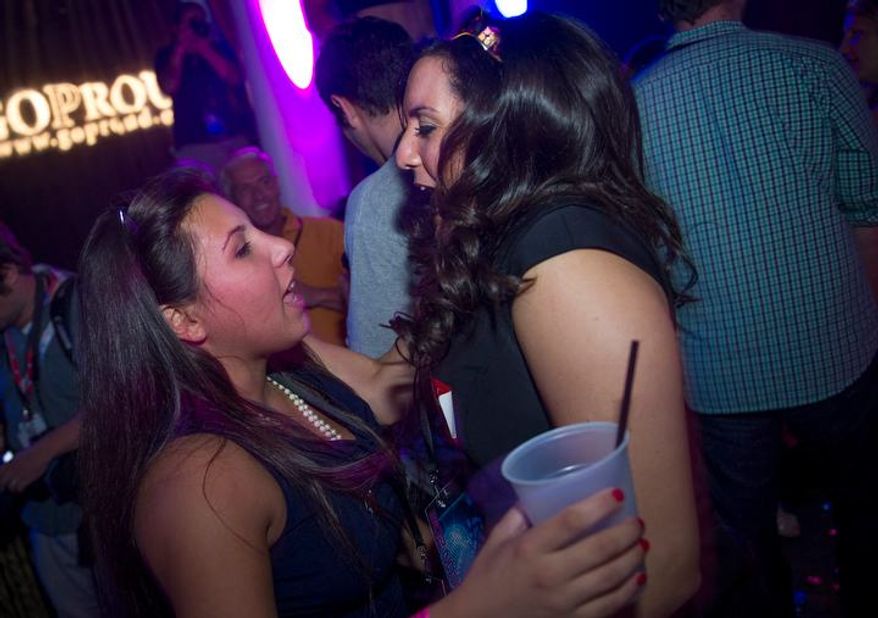 Two women who wished not to be identified dance together during Homocon 2012 at The Honey Pot, following the second night of the Republican National Convention in Tampa, Fla., Wednesday, Aug. 29, 2012. (Rod Lamkey Jr./The Washington Times)