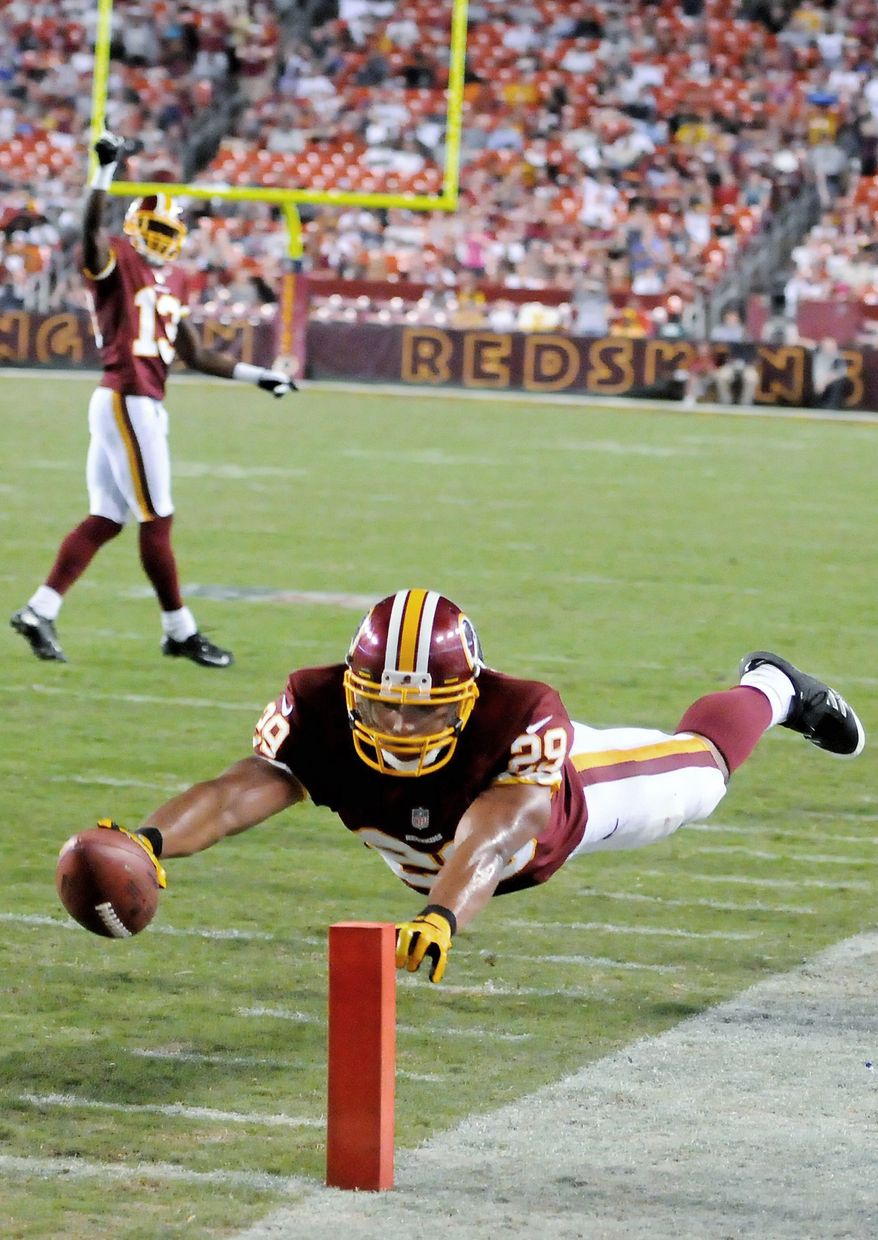 Running back Roy Helu Jr. dives to finish a 15-yard touchdown run Wednesday against Tampa Bay. Helu rushed 15 times for 90 yards and two TDs. (Preston Keres/Special to The Washington Times)