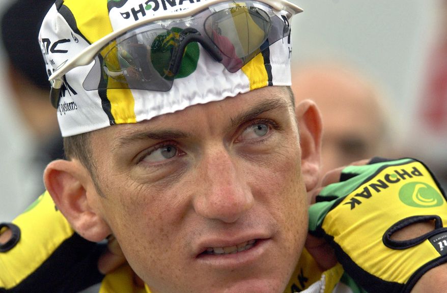 FILE - In this July 1, 2004 file photo, cyclist Tyler Hamilton, of the United States, speaks prior to training with his teammates in Liege, Belgium. Hamilton's tell-all book about Lance Armstrong and doping in cycling will be released two weeks earlier than originally planned. "The Secret Race: Inside the Hidden World of the Tour de France: Doping, Cover-ups, and Winning at All Costs," is now scheduled for release Sept. 5. (AP Photo/Peter Dejong, File)