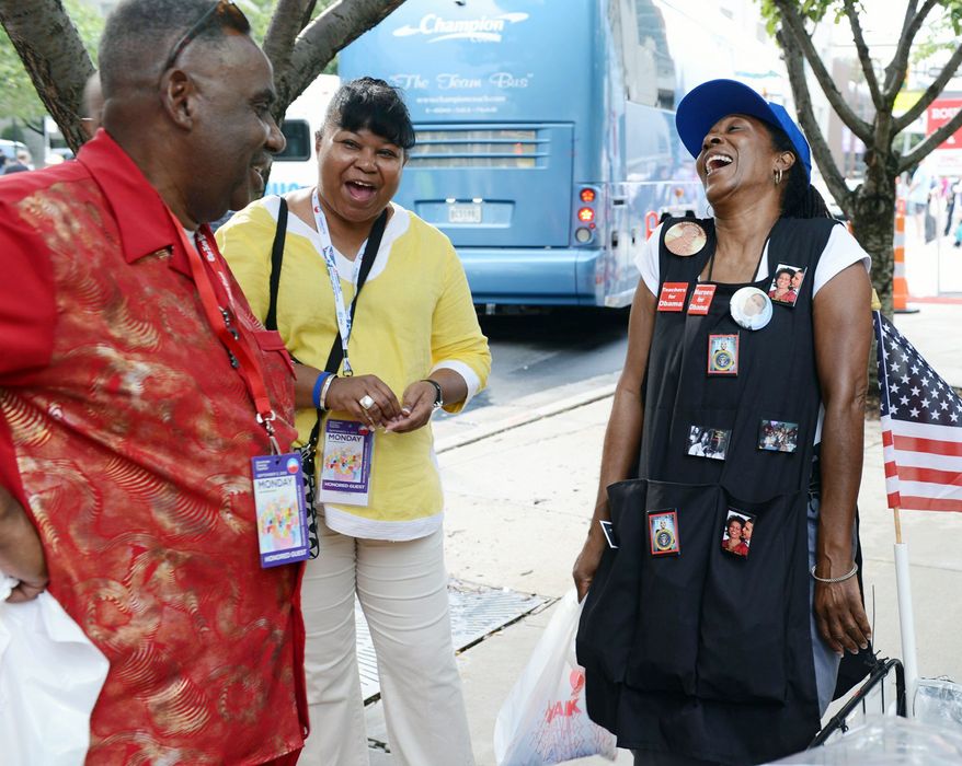 Claudia Blakemore, laughing with Howard Foreman of Louisiana and Audrey Cumby of Texas, has a lucrative business in souvenirs. (Barbara L. Salisbury/The Washington Times)