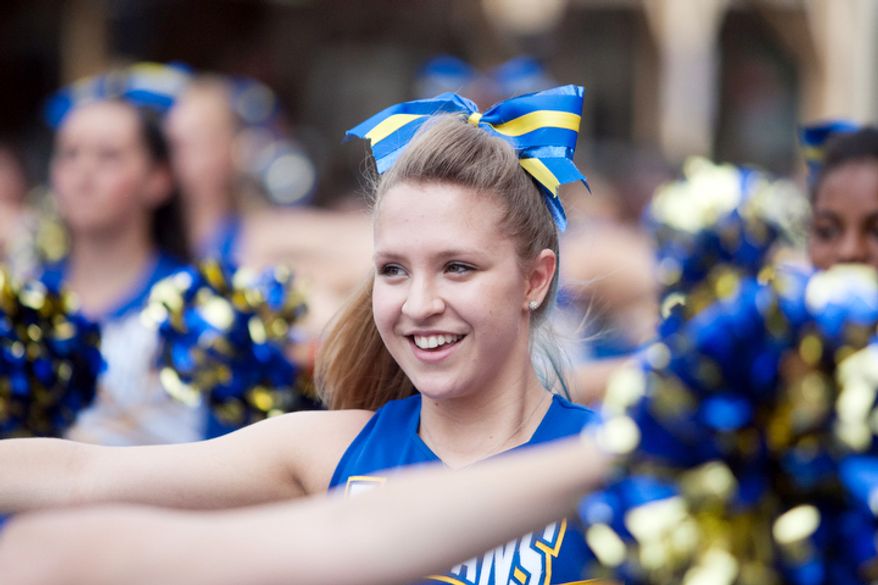 Gaithersburg High School cheerleaders perform while in the Gaithersburg end-of-summer festivity. (Craig Bisacre/The Washington Times)