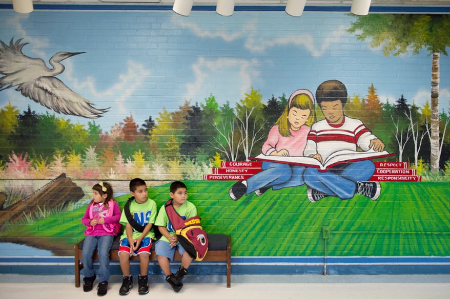 Siblings Kate Castro, left, Jason Castro, second from left, and Christopher Castro, right, wait for class to begin. (Andrew Harnik/The Washington Times)