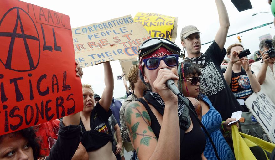 Lauren Digioia (center) of New York City, a member of the Occupy Wall Street movement, addresses fellow protesters on the streets of Charlotte, N.C., outside the Democratic National Convention on Tuesday. (Barbara L. Salisbury/The Washington Times)