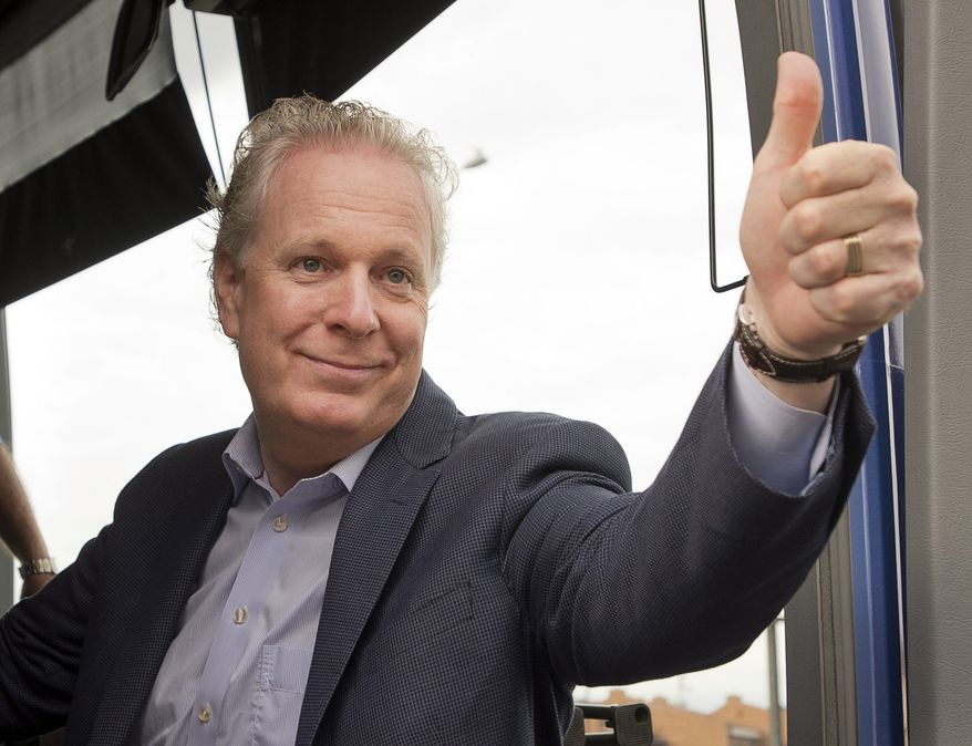 Quebec Premier Jean Charest, the leader of the Quebec Liberal Party, salutes supporters as he campaigns at a riding office in Montreal on Tuesday, Sept. 4, 2012. (AP Photo/Canadian Press, Ryan Remiorz)