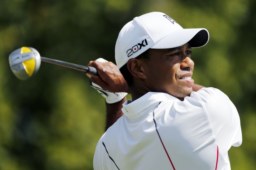 Tiger Woods tees off on the first hole during the third round of the Deutsche Bank Championship PGA golf tournament at TPC Boston in Norton, Mass., Sunday, Sept., 2, 2012. (AP Photo/Michael Dwyer)