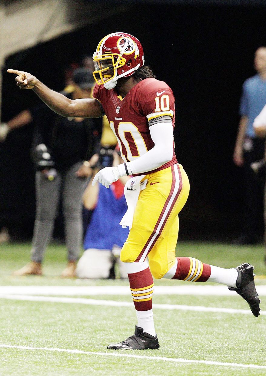 Redskins quarterback Robert Griffin III had plenty of reason to celebrate at he went 19 of 26 for 320 yards and two touchdowns in his NFL debut Sunday. (Associated Press)