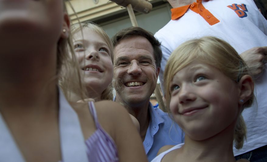 Dutch Prime Minister Mark Rutte poses with children during a campaign visit in Dordrecht, Netherlands, on Saturday, Sept. 8, 2012, four days ahead of national elections. (AP Photo/Peter Dejong)