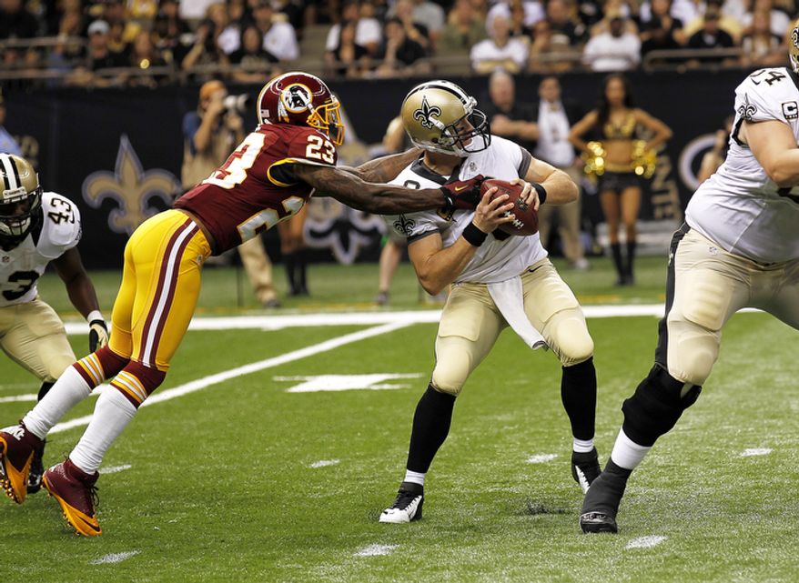 New Orleans Saints quarterback Drew Brees (9) is sacked by Washington Redskins cornerback DeAngelo Hall (23) in the first half of an NFL football game at the Mercedes-Benz Superdome in New Orleans, Sunday, Sept. 9, 2012. (AP Photo/Bill Haber)