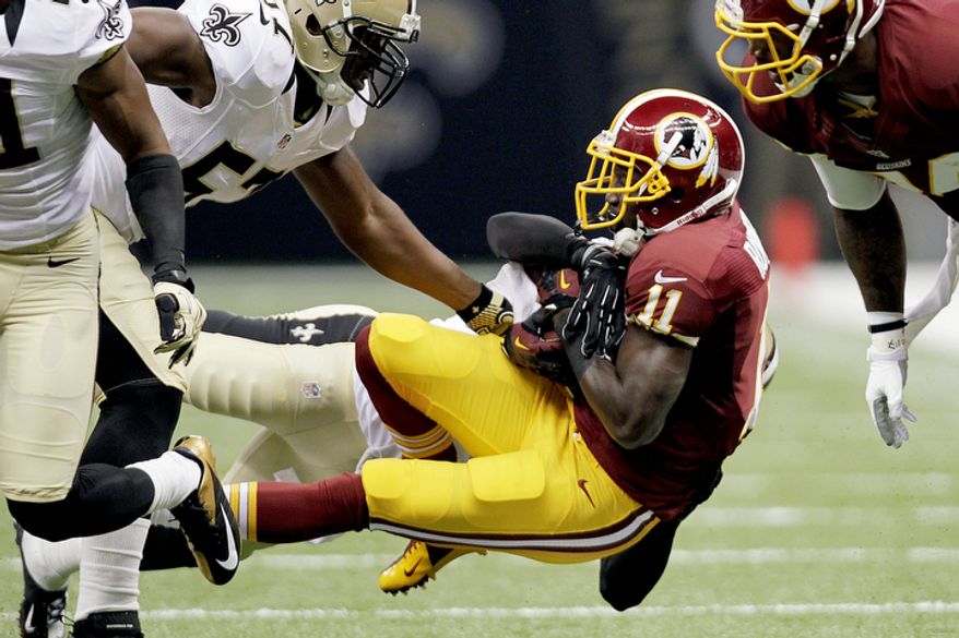 Washington Redskins wide receiver Aldrick Robinson (11) is tackled in the first half of an NFL football game against the New Orleans Saints in New Orleans, Sunday, Sept. 9, 2012. (AP Photo/Gerald Herbert)