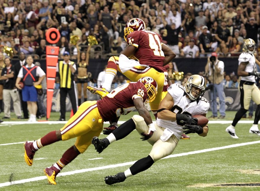 New Orleans Saints tight end Jimmy Graham (80) scores on a touchdown reception in the first half of an NFL football game against the Washington Redskins at the Mercedes-Benz Superdome in New Orleans, Sunday, Sept. 9, 2012. (AP Photo/Matthew Hinton)