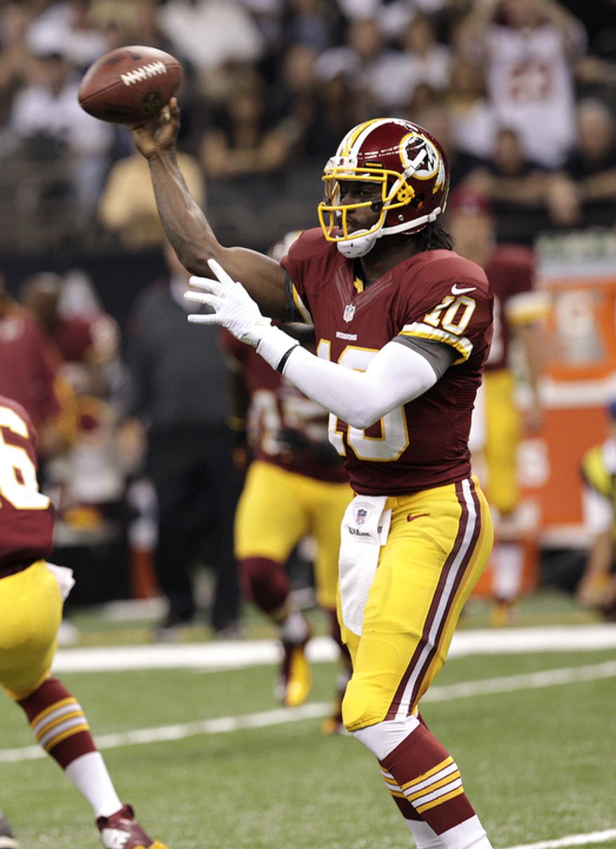 Washington Redskins quarterback Robert Griffin III (10) passes in the first half of an NFL football game against the New Orleans Saints at Mercedes-Benz Superdome in New Orleans, Sunday, Sept. 9, 2012. (AP Photo/Matthew Hinton)