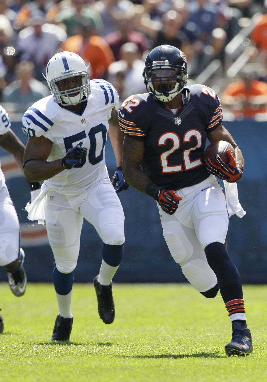 Chicago Bears running back Matt Forte (22) rushes for 32 yards with Indianapolis Colts linebacker Jerrell Freeman (50) pursuing during the first half of an NFL football game in Chicago, Sunday, Sept. 9, 2012. (AP Photo/Nam Y. Huh)