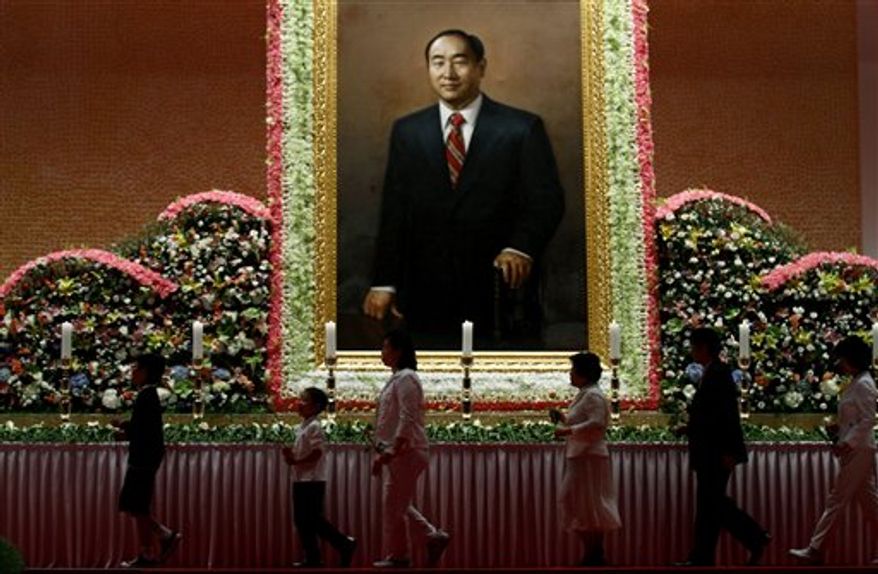 Mourners leave after offering their prayers for late Rev. Sun Myung Moon during a memorial service at the Cheong Shim Peace World Center in Gapyeong, South Korea, Sunday, Sept. 9, 2012. (AP Photo/Hye Soo Nah)