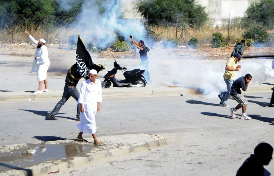 Demonstrators protest outside the U.S. embassy in Tunis on Sept. 14, 2012, as police responded with tear gas. Angry demonstrations against an anti-Islam film spread to their widest extent yet around the Middle East and other Muslim countries Friday, as protesters smashed into the German Embassy in the Sudanese capital and security forces in Egypt and Yemen fired tear gas and clashed with protesters to keep them away from U.S. embassies. (Associated Press)