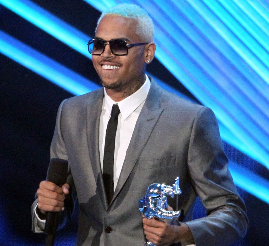 R&B singer Chris Brown accepts the award for best male video for "Turn Up the Music" at the MTV Video Music Awards in Los Angeles on Thursday, Sept. 6, 2012. (AP Photo/Matt Sayles, Invision)
