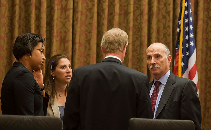 D.C. City Council Chairman, Phil Mendelson, (right) speaks with council member, Jack Evans, (left) before the first council meeting after the summer recess, Wednesday, Sept. 19, 2012, in Washington, DC. (Craig Bisacre/The Washington Times)