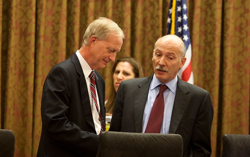 D.C. City Council Chairman, Phil Mendelson, (right) speaks with council member, Jack Evans, (left) before the first meeting after the summer recess, Wednesday, Sept. 19, 2012, in Washington, DC. (Craig Bisacre/The Washington Times)