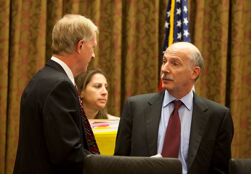 D.C. City Council Chairman, Phil Mendelson, (right) speaks with council member, Jack Evans, (left) before the first meeting after the summer recess, Wednesday, Sept. 19, 2012, in Washington, DC. (Craig Bisacre/The Washington Times)