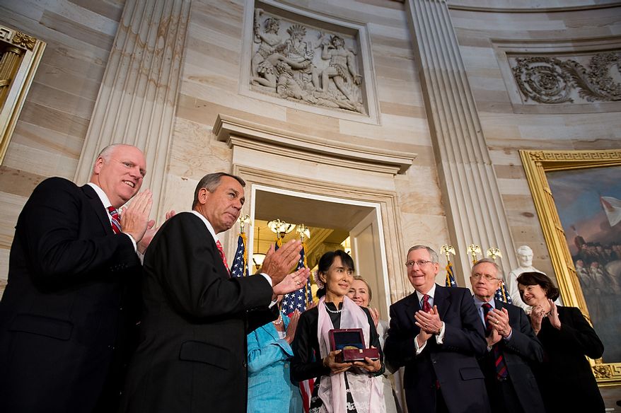 Rep. Joseph Crowley (D-N.Y.), left, Speaker of the House John Boehner (R-Ohio), second from left, Secretary of State Hillary Rodham Clinton, fourth from right, Senate Republican Leader Mitch McConnell (R-Ky.), third from right, Senate Majority Leader Harry Reid (D-Nev.), second from right, and Sen. Dianne Feinstein (D-Calif), right, applaud as Chairperson and General Secretary of the National League for Democracy Aung San Suu Kyi of Myanmar, also known as Burma, is awarded the Congressional Gold Medal in the Capitol rotunda, Washington, D.C., Wednesday, September 19, 2012. (Andrew Harnik/The Washington Times)