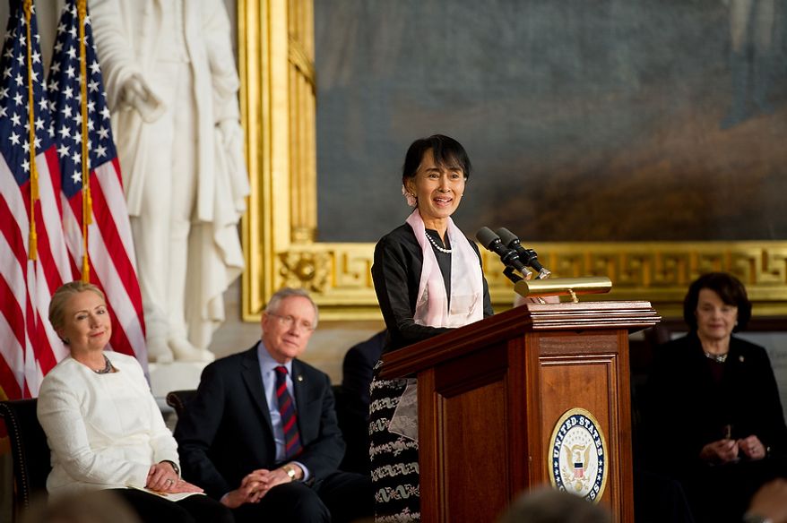Chairperson and General Secretary of the National League for Democracy Aung San Suu Kyi of Myanmar, also known as Burma, speaks after being awarded the Congressional Gold Medal with Speaker of the House John Boehner (R-Ohio), Senate Majority Leader Harry Reid (D-Nev.), second from left, Senate Republican Leader Mitch McConnell (R-Ky.), House Democratic Leader Nancy Pelosi (D-Calif.), Secretary of State Hillary Rodham Clinton, left, Former First Lady of the United States Laura Bush, and Sen. Dianne Feinstein (D-Calif), right, in the Capitol rotunda, Washington, D.C., Wednesday, September 19, 2012. (Andrew Harnik/The Washington Times)
