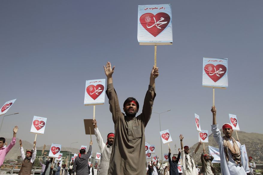 Afghan protesters hold placards with the slogan "Our leader Mohammed" during a demonstration against an anti-Islam film in Kabul, Afghanistan, on Thursday, Sept. 20, 2012. (AP Photo/Ahmad Jamshid)