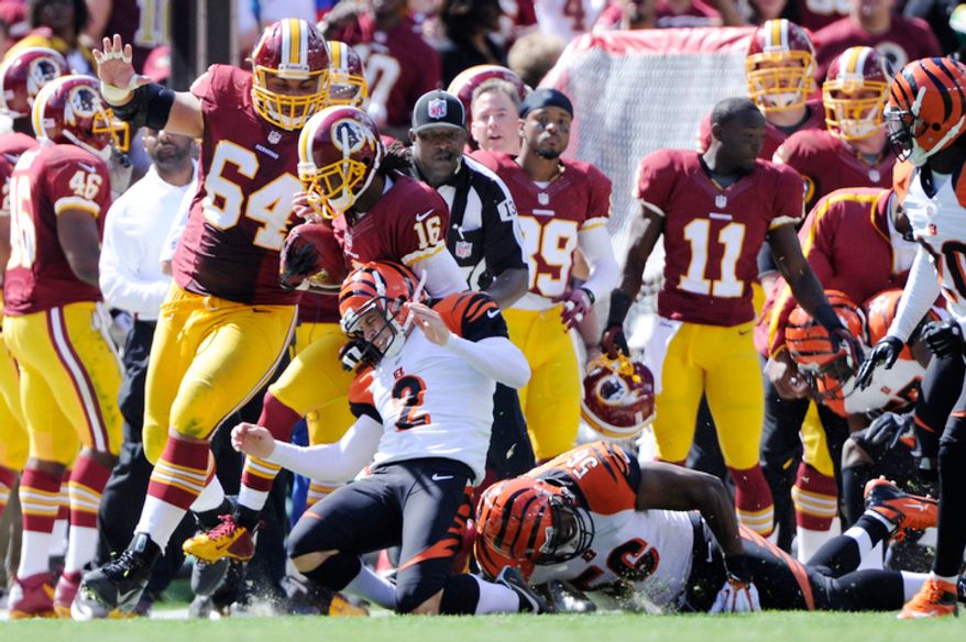 Washington Redskins wide receiver Brandon Banks (16) returns a kickoff 55 yards before being taken down by Cincinnati Bengals kicker Mike Nugent (2) in the second quarter. (Preston Keres/Special to The Washington Times)