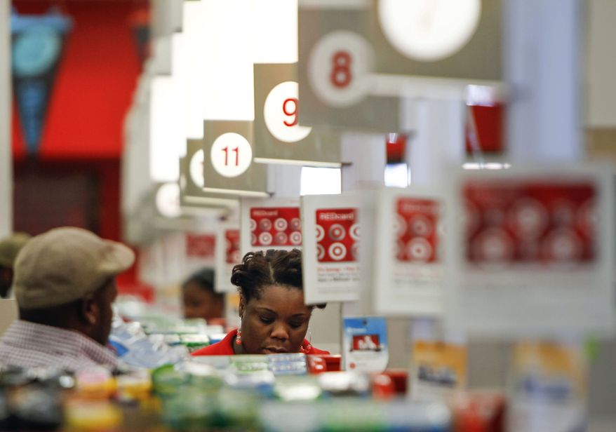 A cashier rings up a sale at a Target store in Chicago on Wednesday, Aug. 22, 2012. (AP Photo/Sitthixay Ditthavong)