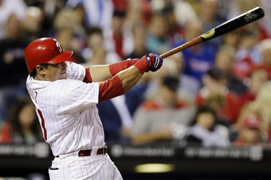 Philadelphia Phillies' Carlos Ruiz follows through after hitting a three-run home run off Washington Nationals starting pitcher Ross Detwiler in the third inning of a baseball game, Tuesday, Sept. 25, 2012, in Philadelphia. (AP Photo/Matt Slocum)