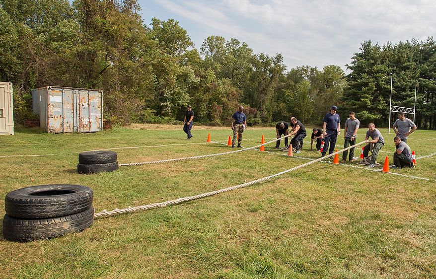 Officers assigned to Metro Transit in Washington D.C., pull tires across a field at the Iron Team Endurance Competition in Laurel, MD., Wednesday, September 26, 2012. The competition is hosted by the Prince George's County Police where teams from all over the east coast, including the Marines, compete in a grueling physical endurance challenge.(Andrew S. Geraci/The Washington Times)