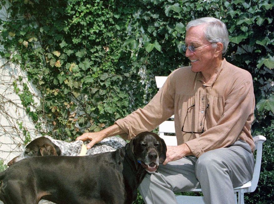 **FILE** Andy Williams spends time with his dogs at his theater in Branson, Mo., on Aug. 25, 2000. (Associated Press)