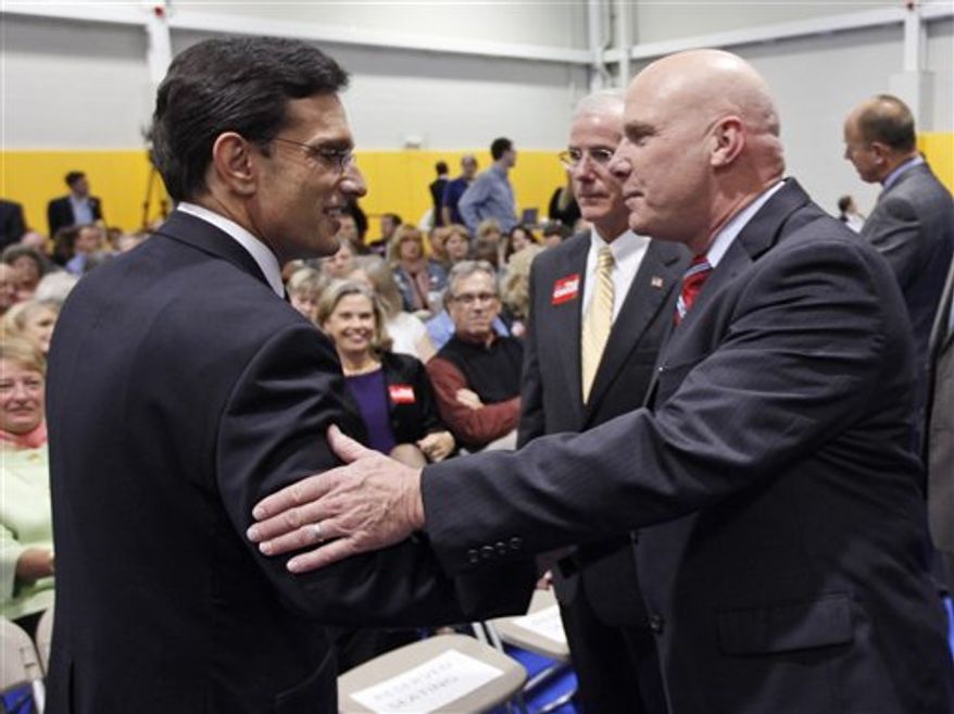 House majority leader Eric Cantor, Virginia Republican, left, and Democratic challenger Wayne Powell greet each other prior to a Chamber of Commerce debate in Richmond, Monday, Oct. 1, 2012. (AP Photo/Steve Helber)