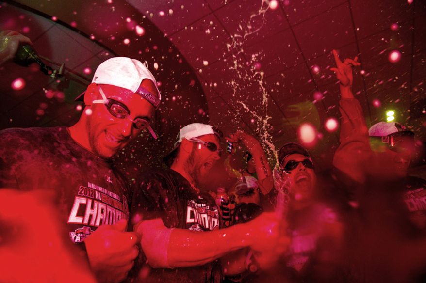 The Washington Nationals celebrate getting into the playoffs in their locker room at Nationals Park. (Andrew Harnik/The Washington Times)