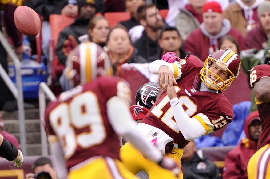 Washington Redskins quarterback Kirk Cousins (12) is hit as he tries to pass in the third quarter at FedEx Field in Landover, Md., on Sunday, Oct. 7, 2012. (Preston Keres/Special to The Washington Times)