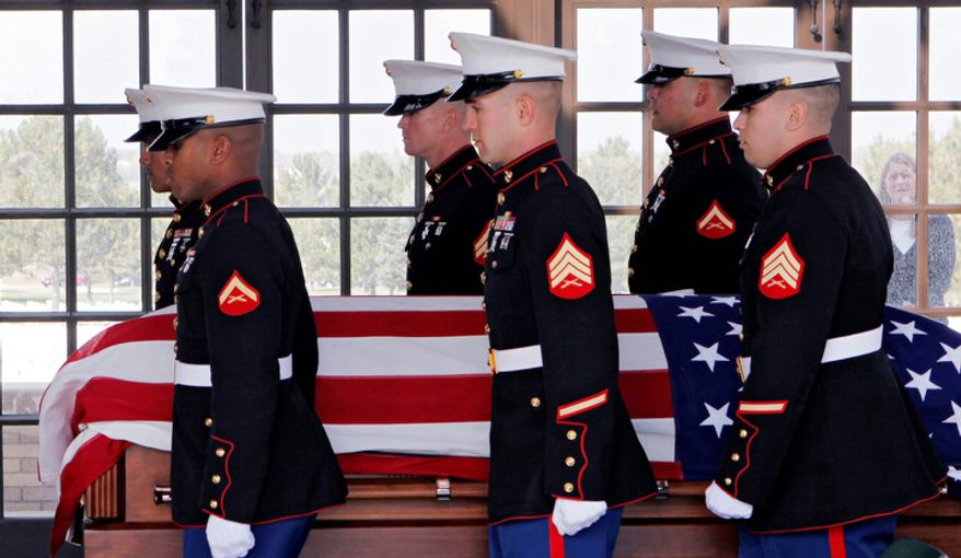 Marine honor guards carry the casket and remains of Marine PFC James Jacques at Fort Logan National Cemetery in Denver. (AP Photo/Ed Andrieski)