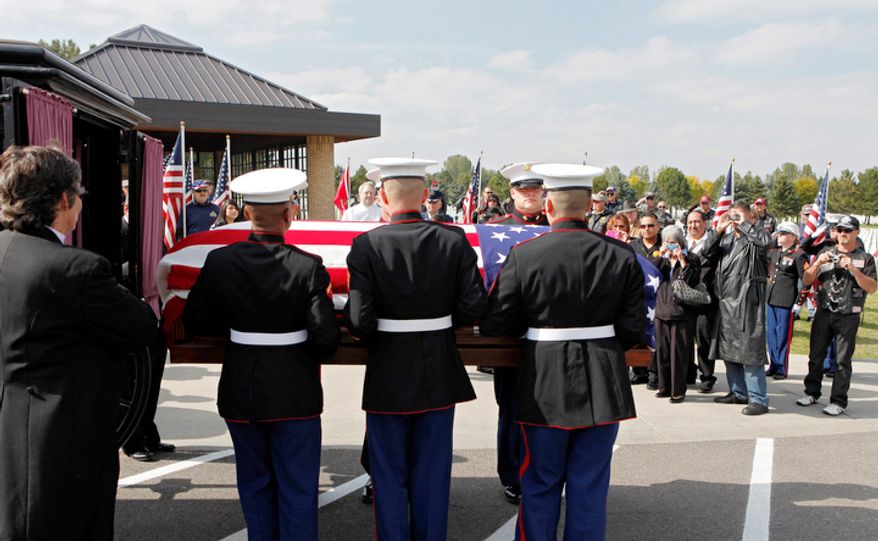 Marine honor guards remove the casket and remains of Marine PFC James Jacques from a carriage at Fort Logan National Cemetery in Denver. (AP Photo/Ed Andrieski)