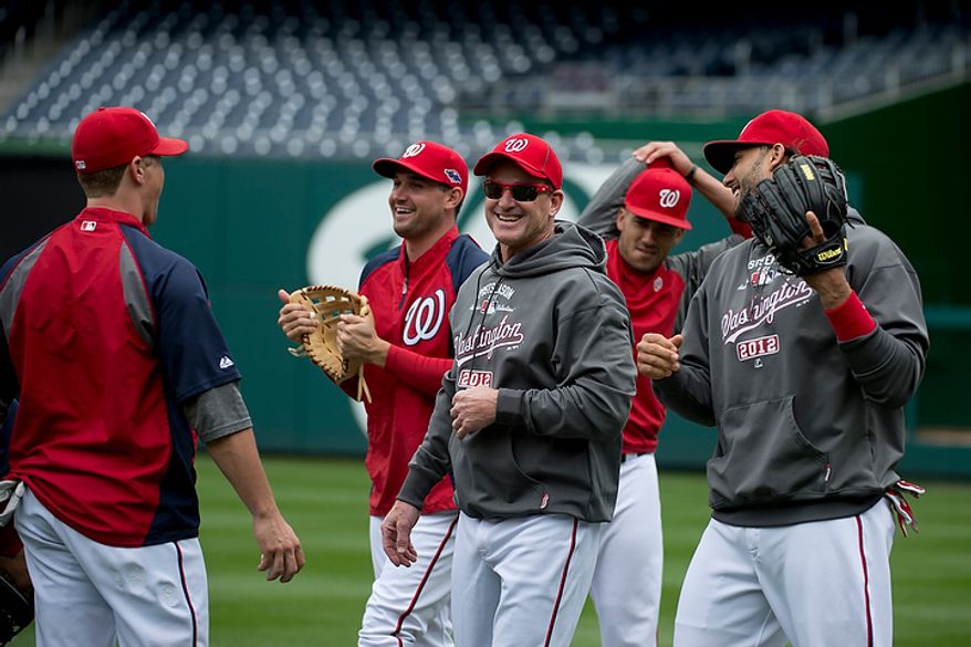 Washington Nationals players laugh and joke during a workout session at Nationals Park on Tuesday, Oct. 9, 2012. On Wednesday, they play the St. Louis Cardinals at home. (Barbara L. Salisbury/The Washington Times)