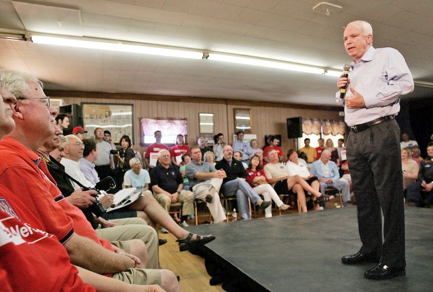 Republican presidential hopeful U.S. Sen. John McCain, of Arizona, talks to a crowd, including Jean and Frank Fahey, left, during a campaign stop in Claremont, N.H., Saturday, July 14, 2007. (AP Photo/Jim Cole)