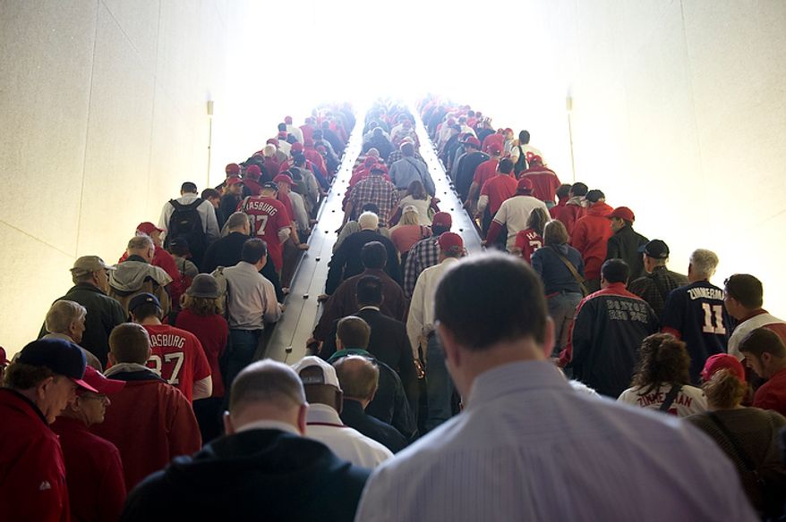 Washington Nationals fans head up the escalator at the Navy Yard station on their way to the ballpark for the first home game in the National League Division Series on Wednesday, Oct. 10, 2012. (Barbara L. Salisbury/The Washington Times)