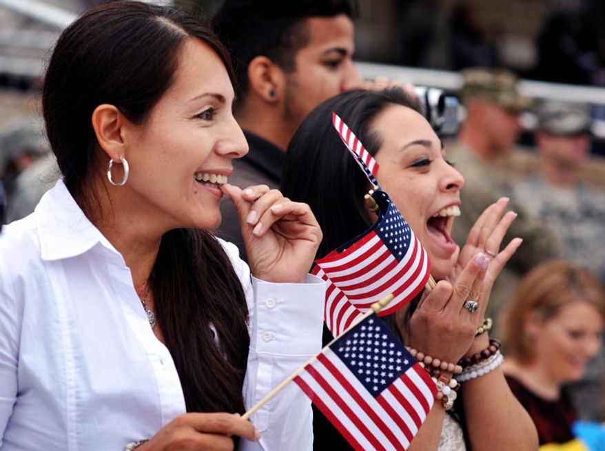 Patricia Parra, left, spots her son PFC Fabian Castrillon in formation along with his fiancee Marivel Penalea, right, during a welcome home ceremony for soldiers from the Army's 1st Battalion, 30th Infantry Regiment, Wednesday, Oct. 10, 2012 at Fort Stewart, Ga. One hundred troops returned home after their first deployment to Afghanistan. Overall about 2,200 soldiers from Fort Stewartís 3rd Infantry Division have deployed to Afghanistan this year. (AP Photo/Stephen Morton)