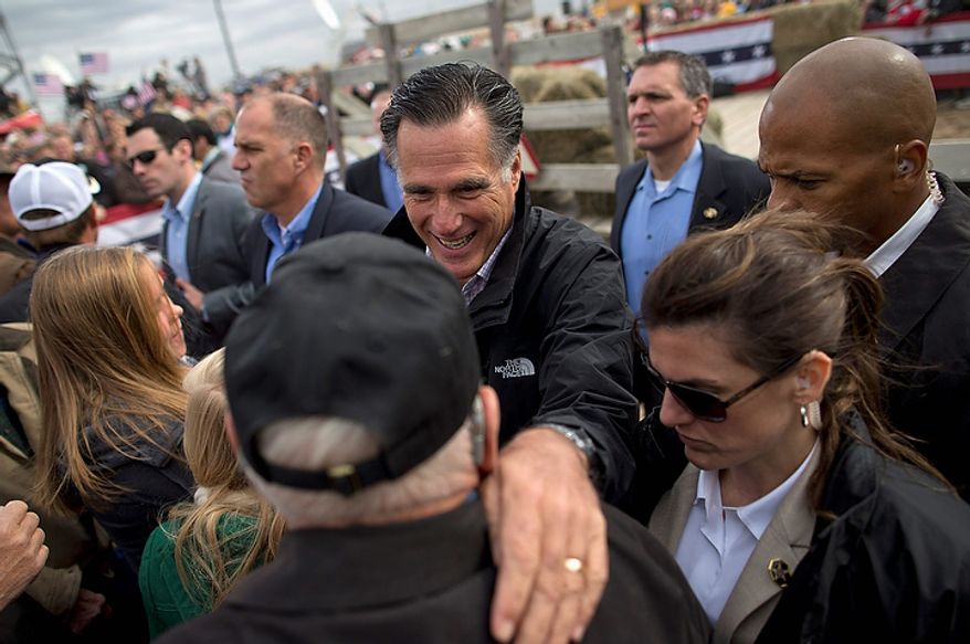 Republican presidential candidate Mitt Romney shakes hands during a campaign rally on Tuesday, Oct. 9, 2012, in Van Meter, Iowa. (AP Photo/Evan Vucci)