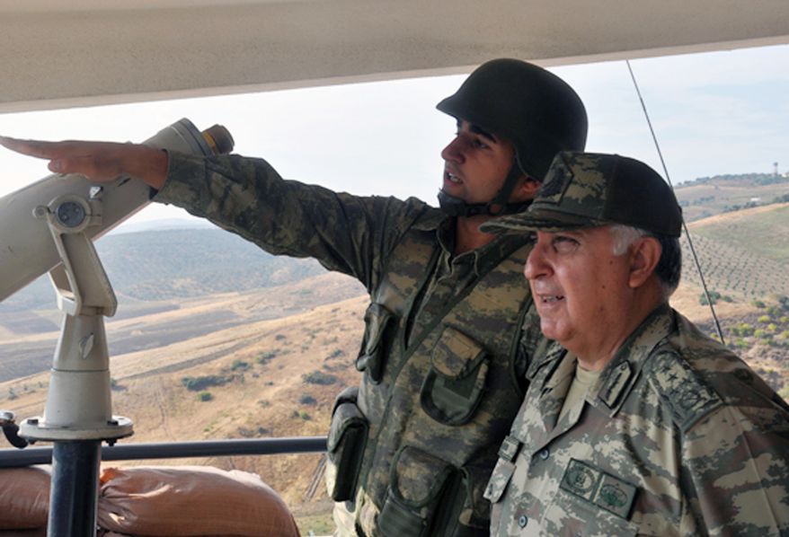 Turkish Chief of Staff Gen. Necdet Ozel (right) listens Oct. 9, 2012, to a commander during his tour of the military along the border with Syria in Hatay, Turkey. (Associated Press/Turkish Military)